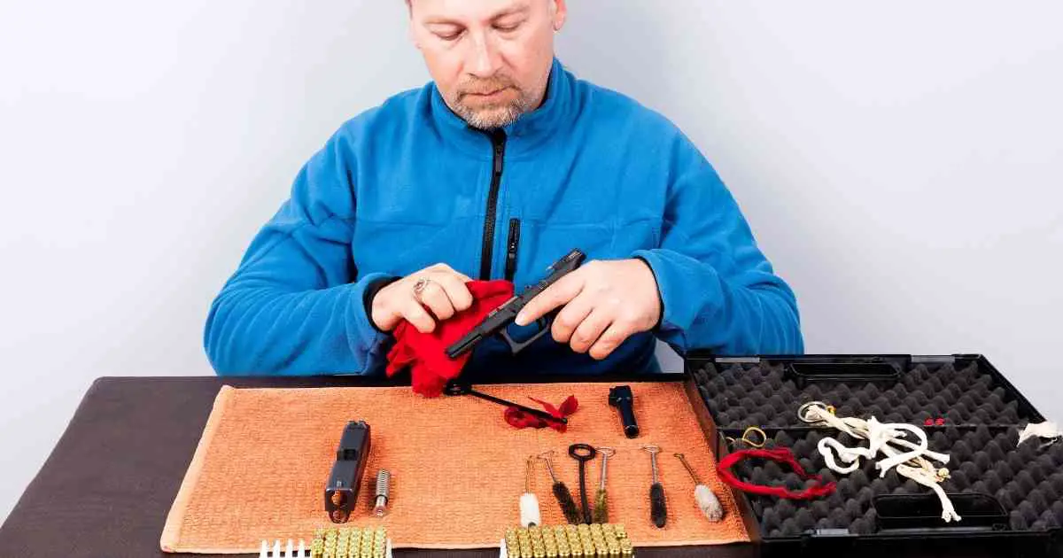man showing how often should i clean my gun